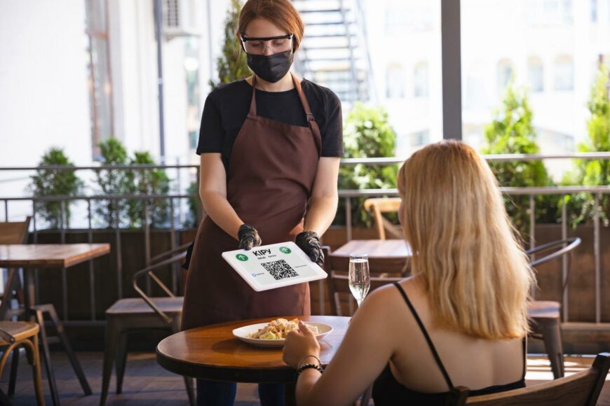 waitress works restaurant medical mask gloves during coronavirus pandemic Алматыда жазғы кафелер жұмыс істейтін болды