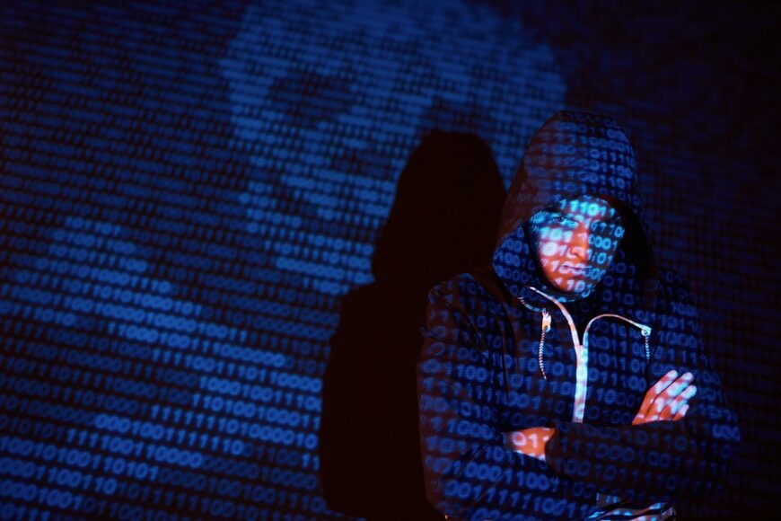 cyber-attack-with-unrecognizable-hooded-hacker-using-virtual-reality-digital-glitch-effect