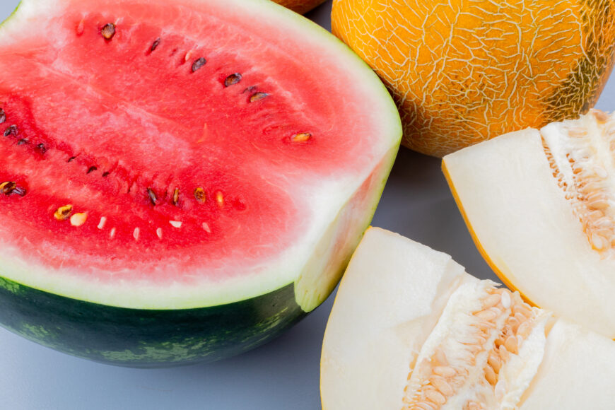 close up view of pattern of cut and whole fruits as watermelon and melon on bluish gray background Экспорт арбузов и дынь из Казахстана приблизился к отметке в $1 миллион.