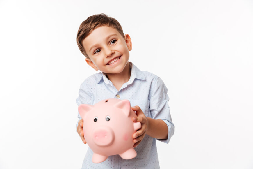 portrait of a cherry cute little kid holding piggy bank Начались первые выплаты средств из Фонда "Нацфонд-детям" в Республике Казахстан